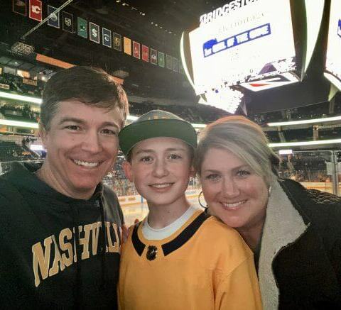 Mark Rankin's wife and son smiling at a predators game.