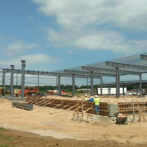 Subcontractors putting up the steel framing for a future food bank.