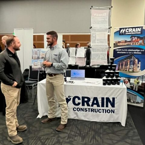 Spencer Rankin is standing in front of the Crain Construction booth at the MTSU Career Fair