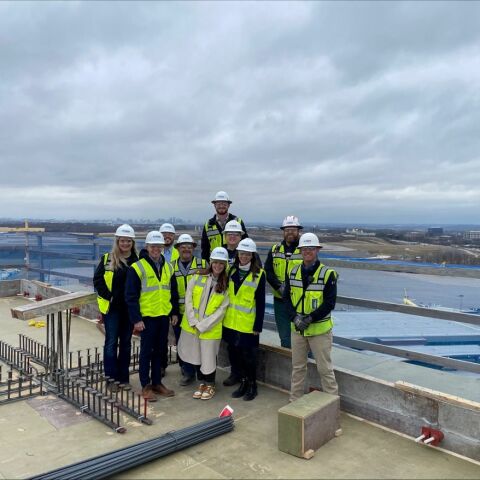 the Crain Construction team on the rooftop of the BNA Hilton with hardhats on a cloudy day