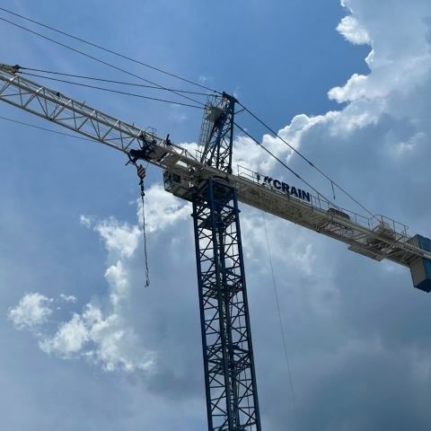 Crain Construction logo on a Crain raised high in the clouds