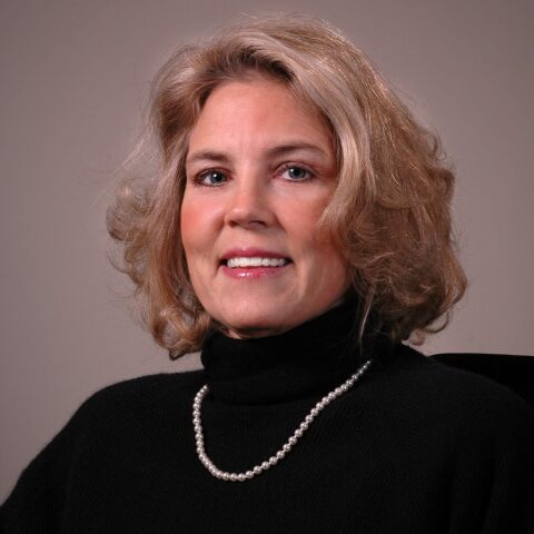 Portrait of Sherry Arledge, wearing professional attire, with a friendly smile, in a well-lit indoor setting.