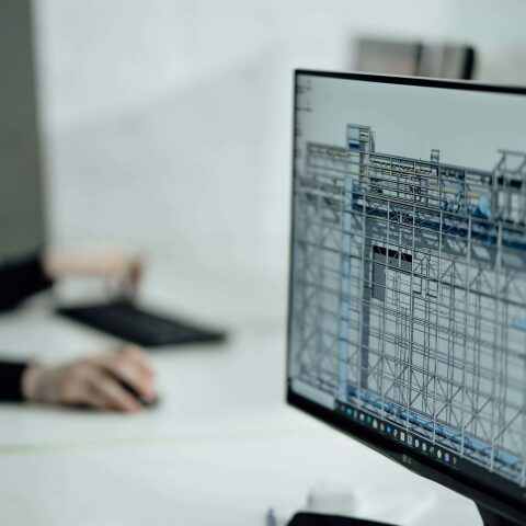 Computer displaying preconstruction software in an office setting