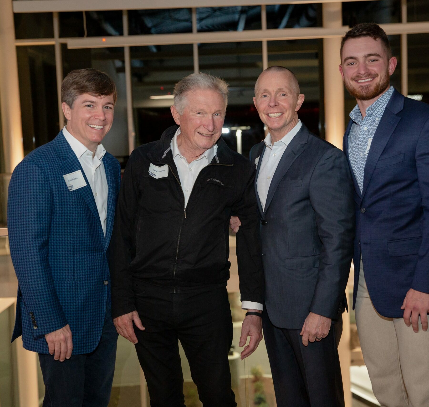 Crain Construction Leadership posing for a photo in suits