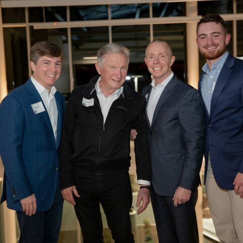 Crain Construction Leadership posing for a photo in suits