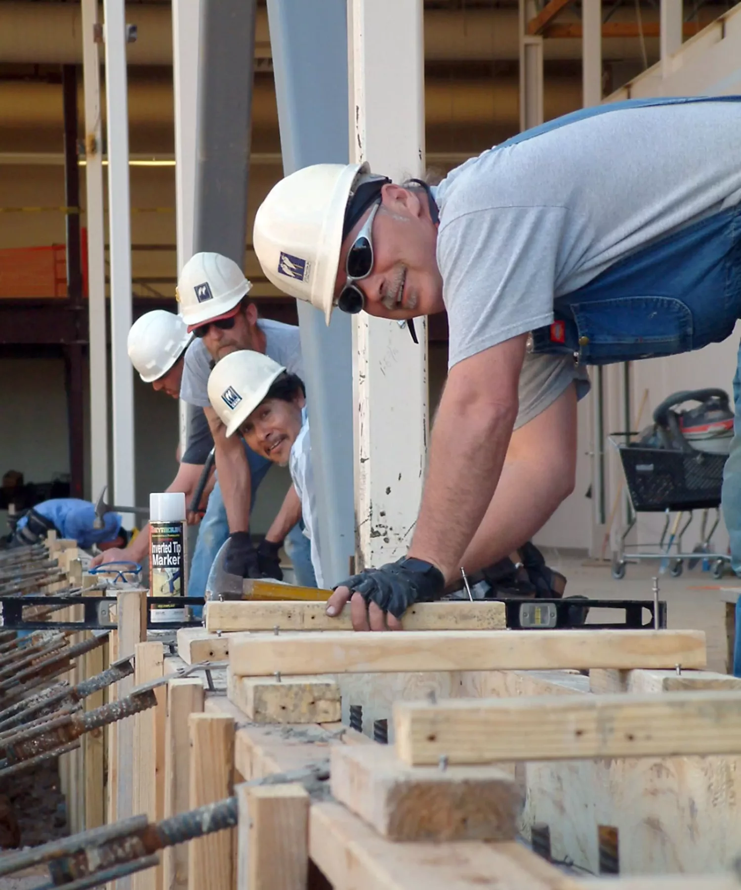 construction workers in hard hats working on a building project
